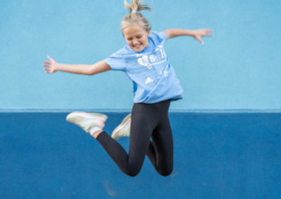A Girls on the Run participant is jumping for joy!